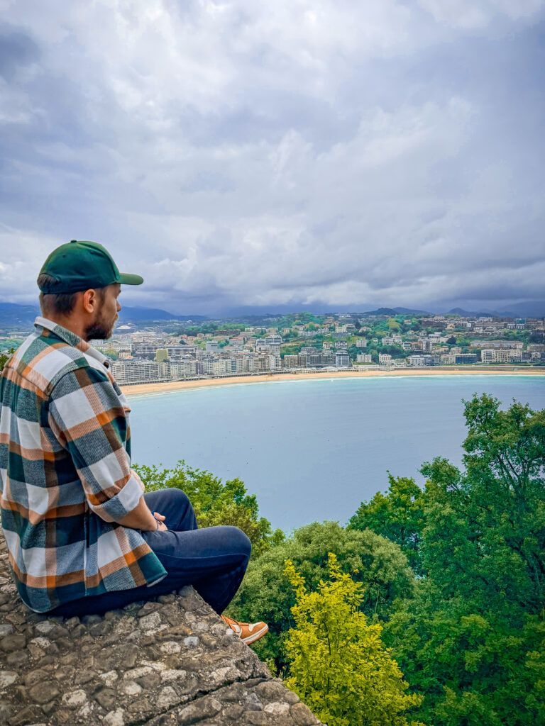 Man overlooking San Sebastián coastline during the final weeks before leaving Europe for full-time world travel.